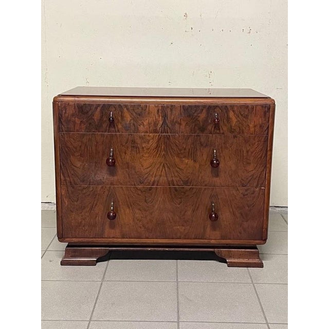 This small Art Deco chest of drawers dates back to the 1930s, featuring curved lines and clean geometric lines typical of...