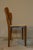 Chair with natural beech structure; curved backrest in polished plywood; seat in die-cast aluminium, straw with knot in...