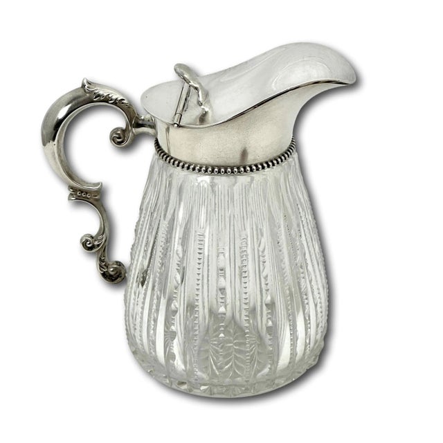 This is an Absolutely Beautiful Antique American Hand Cut Crystal and Sterling Silver Mounted Maple Syrup Pitcher. It...