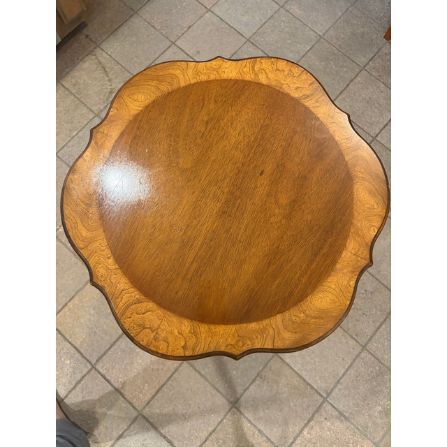 Elegant vintage pedestal side table by Columbia Manufacturing Company featuring a beautifully figured wood top with a...