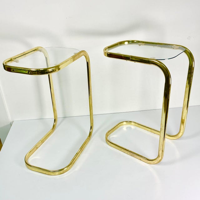 These are a pair of great little Drink Tables from the 1980s. They are a brass like metal finish with glass tops. The...