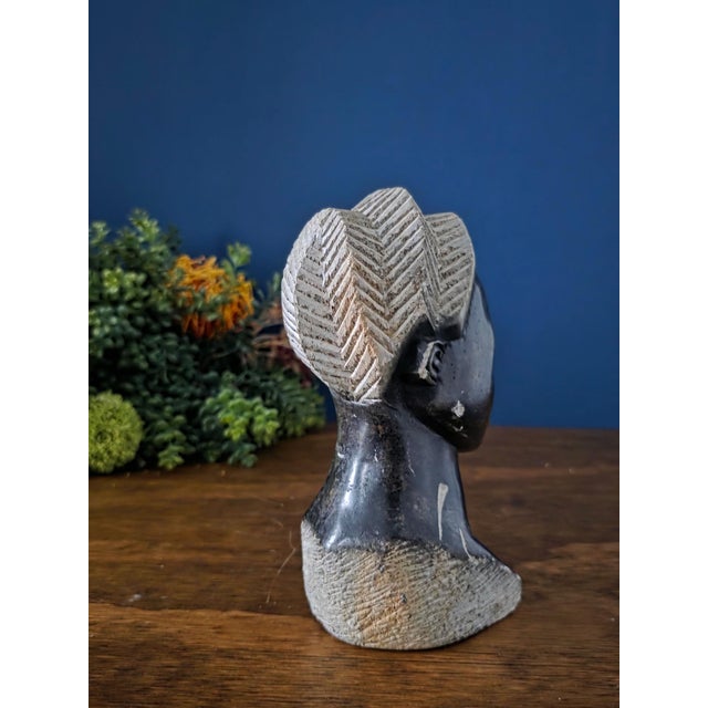 Expressive vintage African hand-carved bust sculpture, skillfully sculpted from dark serpentine stone (soapstone) with...