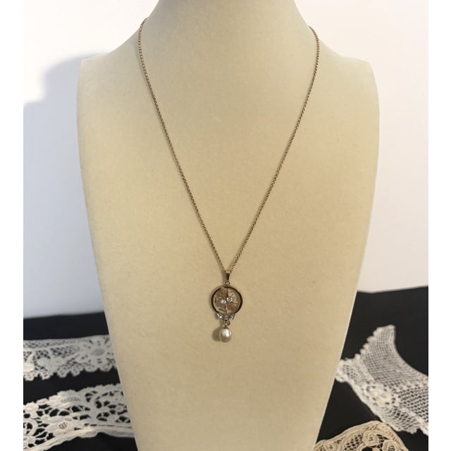 9 CT Gold Fly Necklace with Diamonds, Pearls, and Aquamarine This 9 CT Gold Fly Necklace features a round pendant crafted...