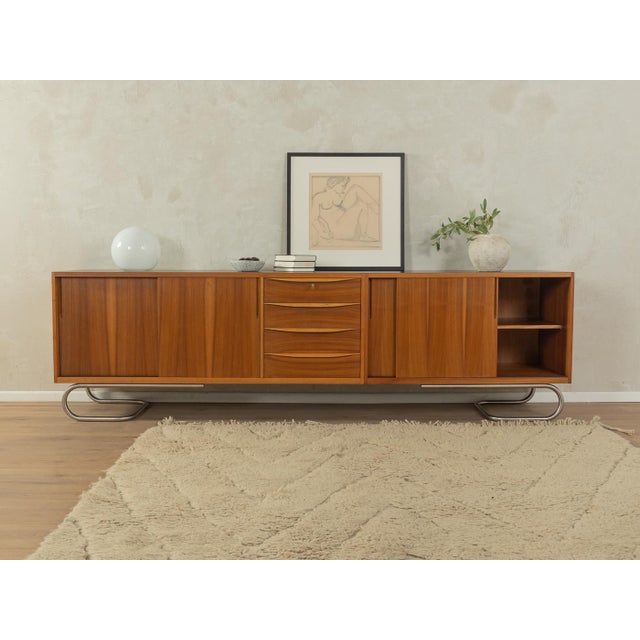 Unique, partially solid sideboard in Scandinavian style from the 1950s. Walnut veneer body with four sliding doors, two...