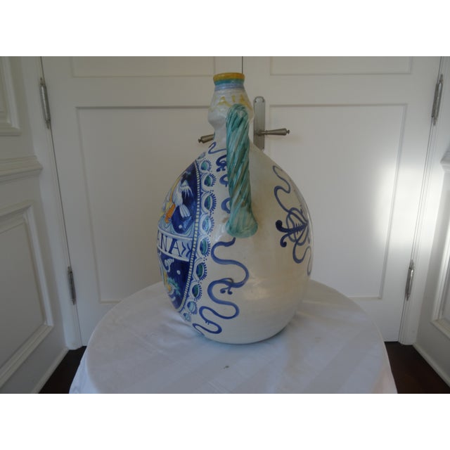 A Beautiful hand painted faience jug from Deruta Italy. Signed by artist on bottom.