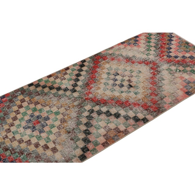 Handknotted in wool, this 3x6 vintage Art deco Zeki Múren rug originates from Turkey, circa 1960-1970 and is latest to...