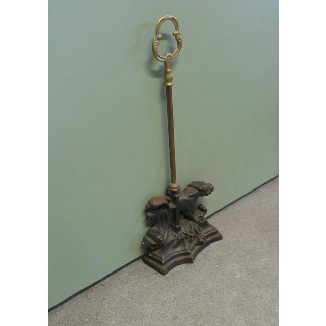 19th Century Cast iron Door Stop, Door Porter Needless to say a heavy piece At the top there is a brass handle to...