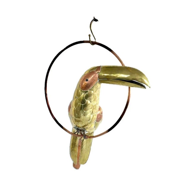 Life-sized brass and copper toucan on a hanging perch handmade by Sergio Bustamante. The world-renowned Mexican artist...