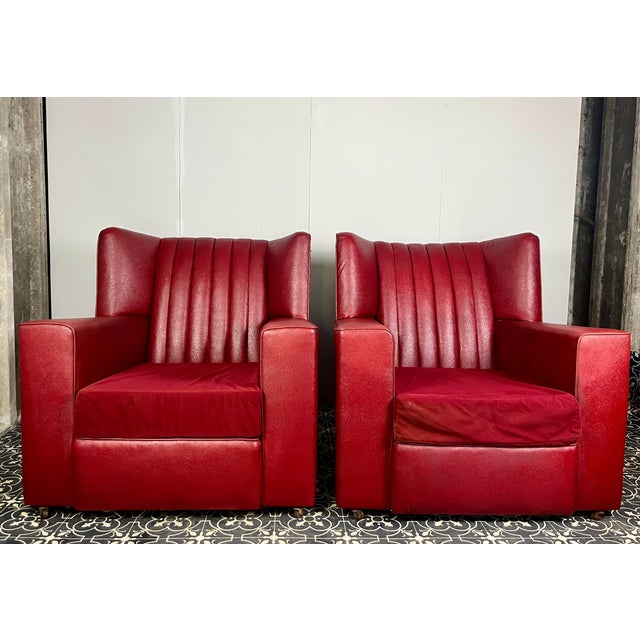A stunning classic 1930’s pair of Art Deco armchairs. A great form, finished in red rexine cloth – a classic British...