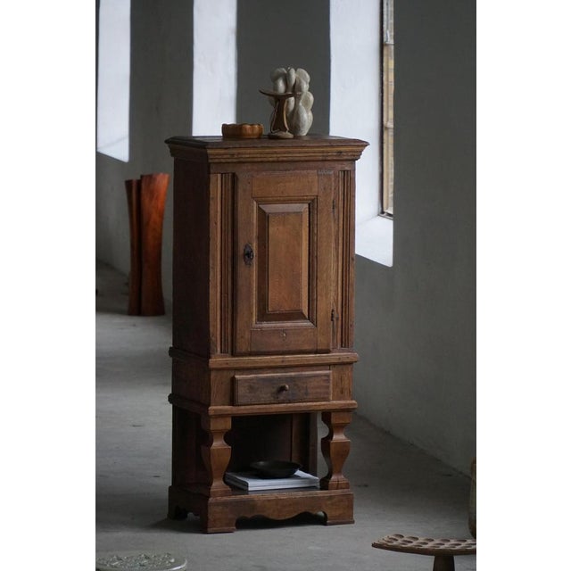 An elegant French mid 19th century cabinet crafted from solid oak, made by a skilled French cabinetmaker. This refined...