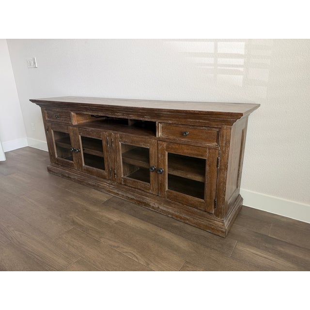 Freestanding 92" credenza with glass doors and 2 drawers; Glass panels can be changed to wood inserts.