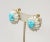 This is part of Chairish’s Costume Jewelry assortment. 1960s goldtone white cylindrical beads with Turquoise beaded center...