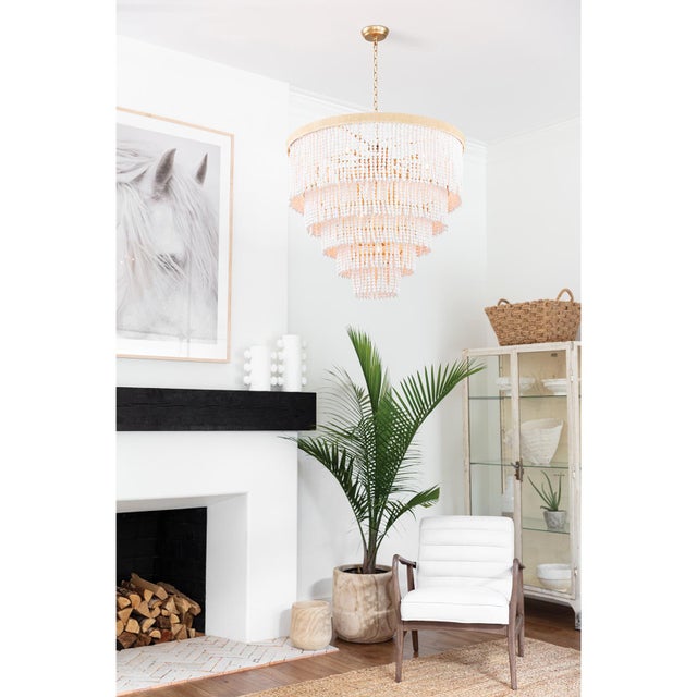Hand-strung rows of fresh white wood beads cascade down and around to create tiers of absolute perfection. This coastal...