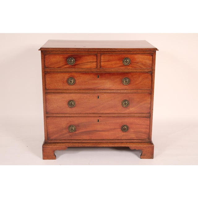 George III mahogany chest of drawers, circa 1800. With a two board top with molded front and side edges, two top drawers...
