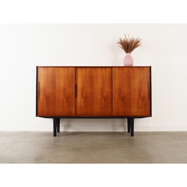 The highboard was made in the 1960s, Danish production. The structure is covered with teak veneer. The legs were made of...