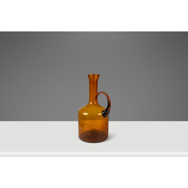 Introducing a Mid-Century Modern blown-glass pitcher that is the very epitome of "one-of-a-kind". In an eye catching...