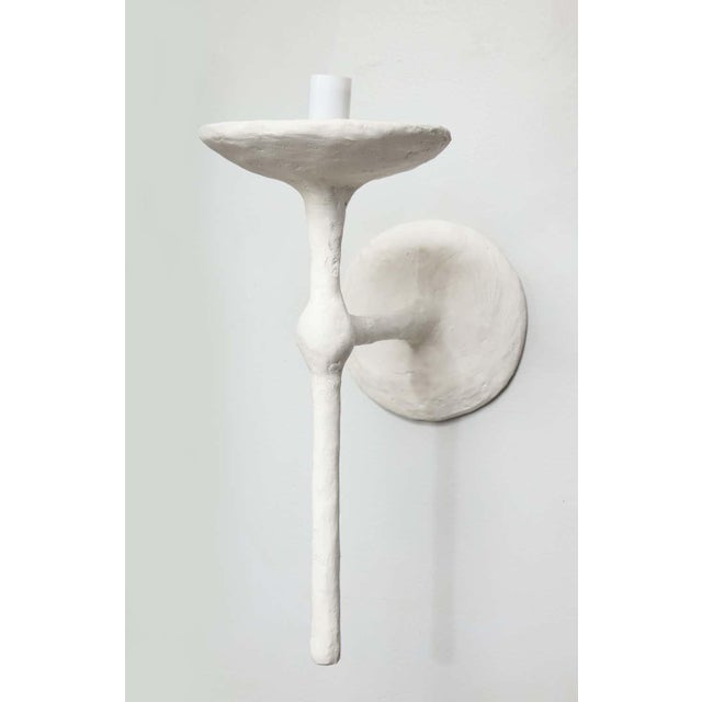 Pair of Bespoke single-arm plaster sconces in the manner of Giacometti, 21st century. Please note that the sconces takes...