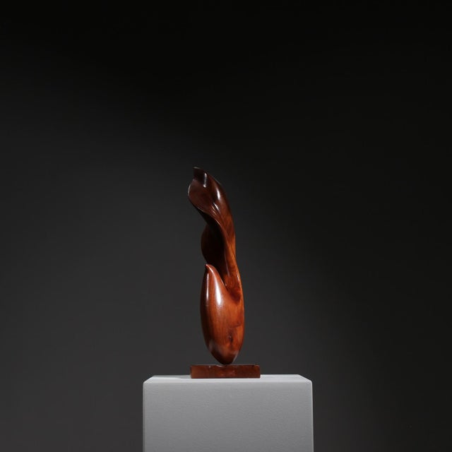 Abstract wooden sculpture from the 1980s. This finely hand-carved art piece features fluid, elegantly curved lines. It is...