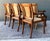 Elevate your dining space with this stately set of five vintage Anglo-Indian dining chairs, a masterful blend of British...
