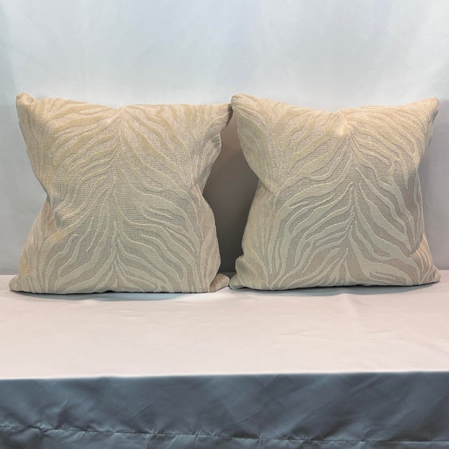 Beautiful woven cream colored animal print 20”x20” includeds new feather/down pillows inserts. Hidden zipper closures....