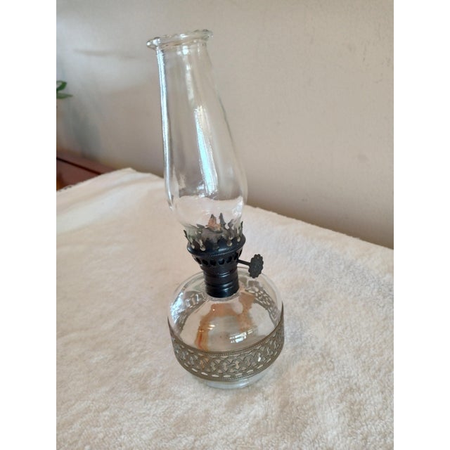 Vintage Miniature Oil Lamp, Clear Glass with Pierced Silver Metal Band. Oil lamp is in great vintage condition without...