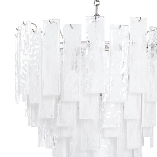 Panes of striking water glass adorn the Small Glacier chandelier to create a dynamic piece full of movement. The glass...