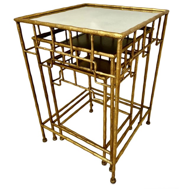 Chic gilt metal fretwork design nesting tables with lightly mirrored glass tops. The glass tops are removable. Table...