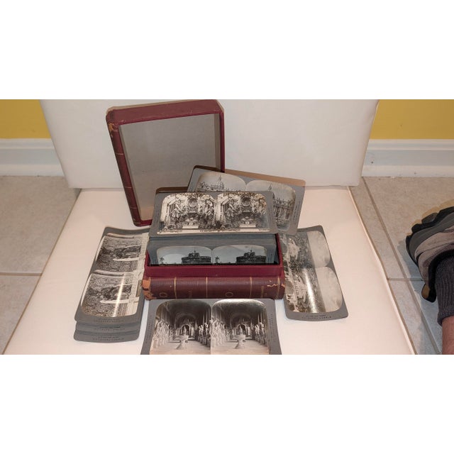 Boxed set of stereo views of Italy in a box designed as two books by the Stereo Travel Company. 99 cards containing city...