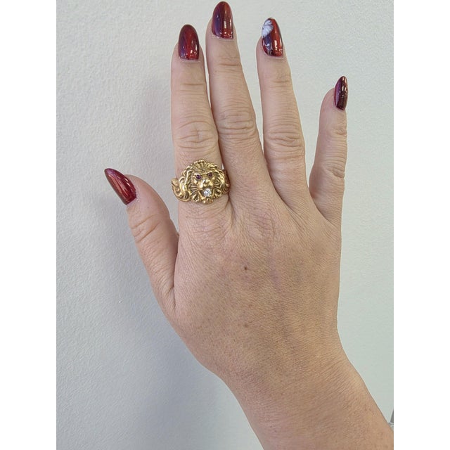 We offer free 2-day shipping! This is a vintage lion head ring with a natural diamond set in it's mouth Circa 1940s...