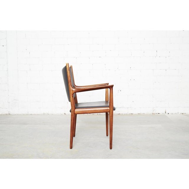 Condition: frame made of solid teak. Seat and backrest upholstered in dark gray faux leather. There is a tiny blemish on...