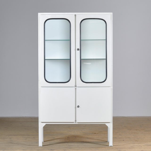 Vintage medical cabinet from the 1970s, manufactured in Hungary. This characterful cabinet is constructed from iron and...
