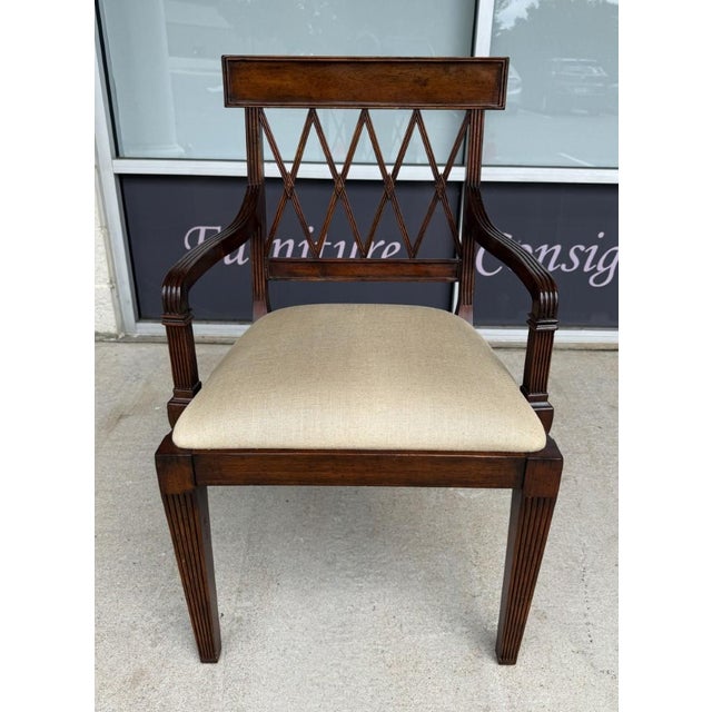 This Jonathan Charles arm chair features a graceful Regency-inspired silhouette with an open lattice back, reeded arms and...