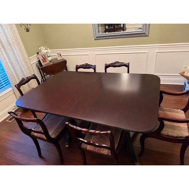 Solid cherry dining table with six matching chairs by Davis Cabinet Company of Nashville, Tennessee. Believed to date to...