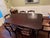 Solid cherry dining table with six matching chairs by Davis Cabinet Company of Nashville, Tennessee. Believed to date to...