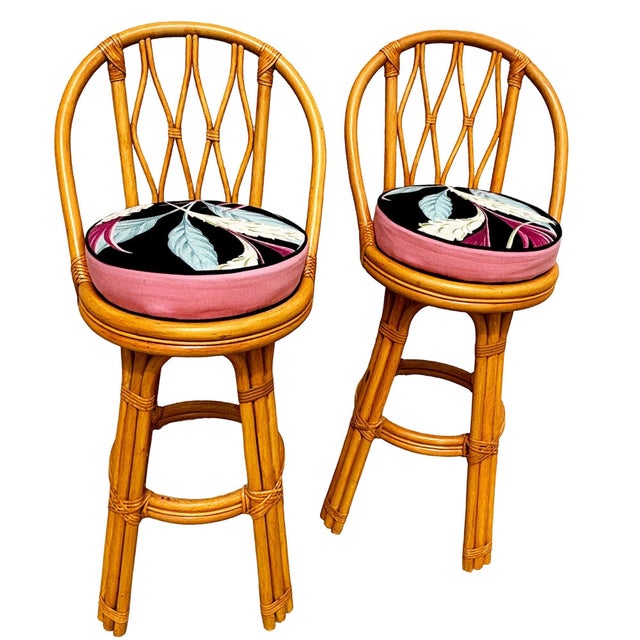 This set of three restored 1950s rattan bar stools, each stool is crafted with arches on each side of the stool, three-...