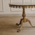 The round side table with its cast brass frame and removable marble top follows the Louis XV design principles and dates...