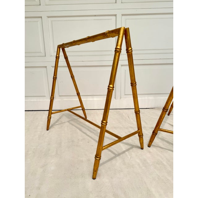 This vintage pair of gilt faux bamboo metal table bases was likely produced in the late 20th century (1970-80s) and...