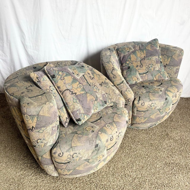 Sculptural and unmistakably postmodern, this striking pair of Nautilus swivel chairs features bold rounded silhouettes...