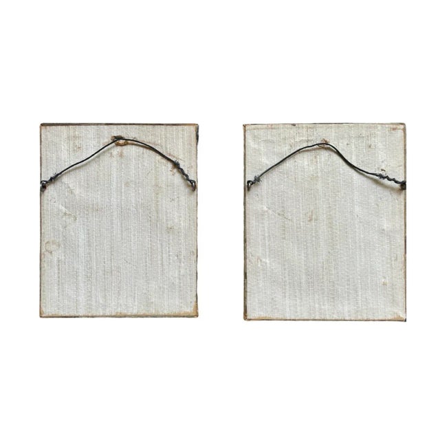 A playful pair of embroidered portraits depicting a Victorian era man and woman in red, white, and blue garb engaged in a...