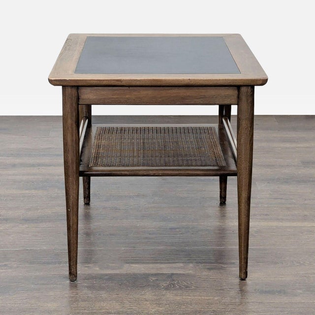 American of Martinsville mid-century occasional table with a pull-out drawer and a caned shelf underneath. The table is...