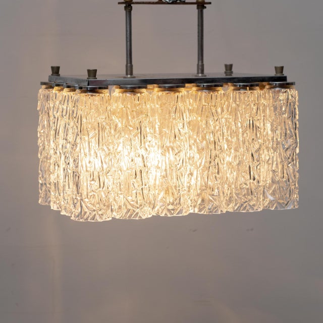 1970s designer chandelier. Metal frame with worked glass elements. Excellent condition. Item as shown in the photos. Up to...