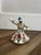 Small, handmade ceramic Whirling Dervish figurine from Kütahya featuring a smooth white glazed finish and an attached gold...