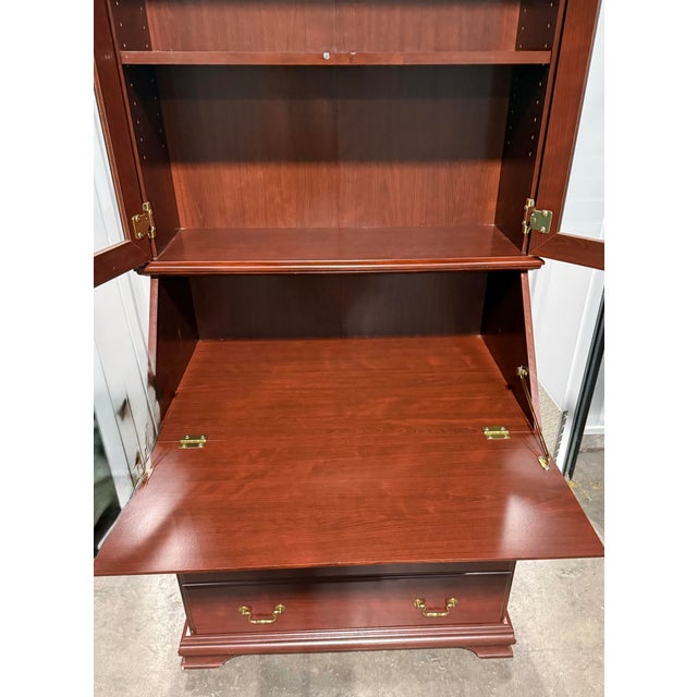 This elegant piece is a classic Chippendale-style secretary desk crafted from mahogany that can serve as a functional...