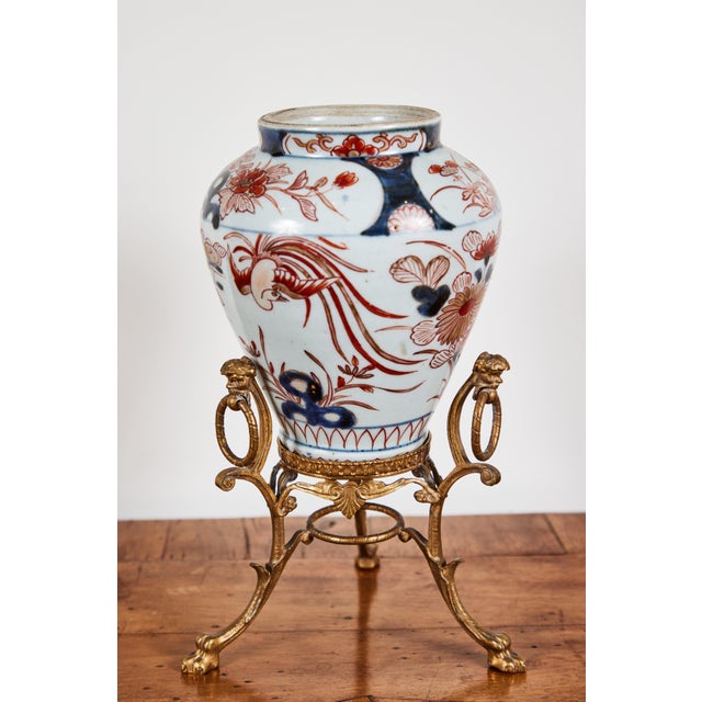 A lovely pair of petite, 19th century, hand painted, parcel-gilt, porcelain Imari vases on detailed, ormolu, tripod stands...