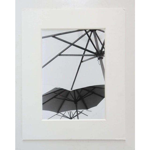 Vintage black and white photograph of umbrellas. Signed on verso E Manclark. Unframed, displayed in mat and backing,...