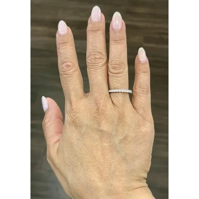 This beautiful eternity ring showcases 28 round brilliant diamonds. The diamonds boast a color of E/F and VS2/SI1. A...