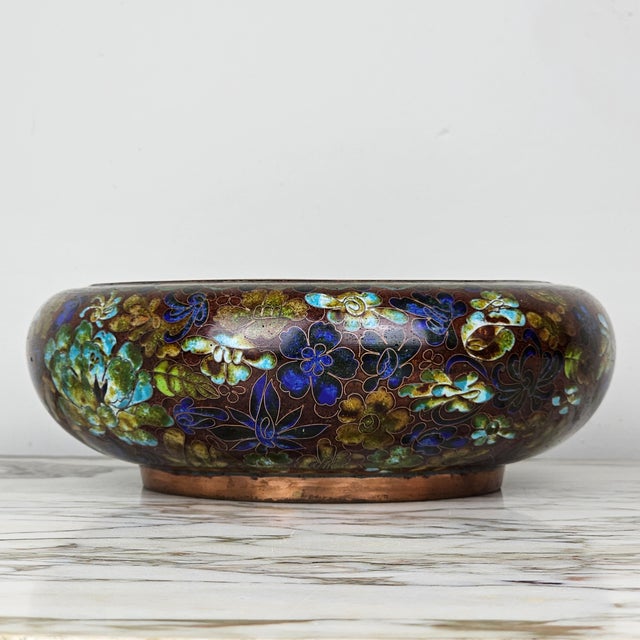 A richly colored early 20th Century antique cloisonne enamel bowl, decorated with scrolling flowers in shades of blue,...