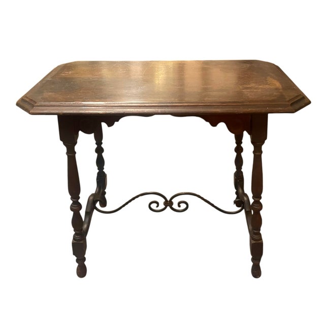 Spanish Revival Victorian Jacobean-style accent table with turned legs and an iron scroll stretcher — a desirable...