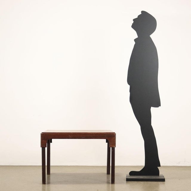 Vintage Italian-made coffee table with square top made of wood with exotic wood veneer. This piece is attributed to the...