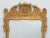 Gilt carved frame with plumes. Beveled mirror.